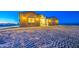 Cozy single-story home featuring an inviting facade, warm outdoor lighting, and a serene desert landscape at 3033 N 367Th Ave, Tonopah, AZ 85354