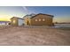Charming single-story home featuring a combination of white and brown paneling under a twilight sky at 3033 N 367Th Ave, Tonopah, AZ 85354