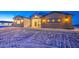 Charming single-story home featuring a combination of white and brown paneling under a twilight sky at 3033 N 367Th Ave, Tonopah, AZ 85354