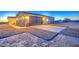 View of the side of the single-story home with garage and hose at 3033 N 367Th Ave, Tonopah, AZ 85354