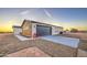 View of the side of the single-story home with garage and hose at 3033 N 367Th Ave, Tonopah, AZ 85354