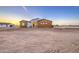 A modern home showcases wood accents, desert landscaping, and a beautiful desert landscape at 3033 N 367Th Ave, Tonopah, AZ 85354