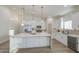 Bright kitchen features a large island, stainless steel appliances, and modern pendant lighting at 3033 N 367Th Ave, Tonopah, AZ 85354