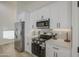Kitchen showcasing stainless steel appliances, white cabinetry, and modern design elements at 3033 N 367Th Ave, Tonopah, AZ 85354