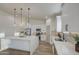 Spacious kitchen with white cabinets, stainless steel appliances, and a waterfall island at 3033 N 367Th Ave, Tonopah, AZ 85354