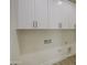 Functional laundry room with built-in cabinets and essential utility connections at 3033 N 367Th Ave, Tonopah, AZ 85354
