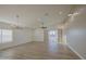 Bright and airy living room featuring wood-look tile floors, large windows, and stylish light fixtures at 3033 N 367Th Ave, Tonopah, AZ 85354