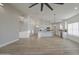 Bright, open living space with wood-look tile floors, a modern ceiling fan, and a view of the kitchen at 3033 N 367Th Ave, Tonopah, AZ 85354