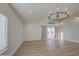 Cozy living room with a contemporary chandelier, ceiling fan, and access to the outdoor space at 3033 N 367Th Ave, Tonopah, AZ 85354