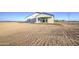 The rear exterior reveals a bright, single story home with a sliding glass door and small porch at 3033 N 367Th Ave, Tonopah, AZ 85354
