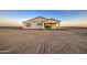 A bright home's exterior showcases a covered patio with a sliding glass door and minimal landscaping at 3033 N 367Th Ave, Tonopah, AZ 85354
