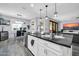 Contemporary kitchen island with black granite countertops, pendant lighting, and stainless steel appliances at 3713 W Abrams Dr, New River, AZ 85087