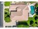 Aerial view of a home with a pool, patio, well manicured backyard, and mature landscaping at 3931 E Fox Cir, Mesa, AZ 85205
