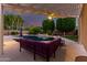 Tranquil backyard featuring a pool, covered patio with a ceiling fan, and lush landscaping at 3931 E Fox Cir, Mesa, AZ 85205