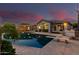 Backyard oasis with a sparkling pool, diving board, covered patio, and well-maintained landscaping at 3931 E Fox Cir, Mesa, AZ 85205