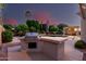 Outdoor kitchen area featuring a built-in grill, a pool, and a covered patio area perfect for entertaining at 3931 E Fox Cir, Mesa, AZ 85205