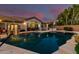 Inviting backyard with a pool, basketball hoop, patio with dining area, and lush landscaping at 3931 E Fox Cir, Mesa, AZ 85205