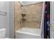 Detailed view of a bathtub with tiled walls and built-in shelving in a bathroom at 3931 E Fox Cir, Mesa, AZ 85205