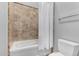 Cozy bathroom features a bathtub with tiled walls and a shower curtain at 3931 E Fox Cir, Mesa, AZ 85205