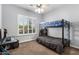 Bedroom with gray walls featuring a bunk bed, ceiling fan, and a window with white shutters at 3931 E Fox Cir, Mesa, AZ 85205
