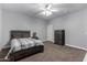 Inviting bedroom with neutral walls and carpet, complemented by a modern ceiling fan at 3931 E Fox Cir, Mesa, AZ 85205