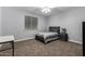 Comfortable bedroom with large window, ceiling fan and neutral-colored walls and carpeted flooring at 3931 E Fox Cir, Mesa, AZ 85205
