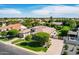 Stunning single-story home featuring lush landscaping, mature trees, and a circular driveway on a corner lot at 3931 E Fox Cir, Mesa, AZ 85205