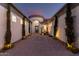 Inviting front entrance featuring a serene water feature, brick-paved driveway, and beautiful landscaping at 3931 E Fox Cir, Mesa, AZ 85205