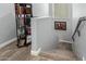 Hallway featuring carpeted stairs leading to an upper level with railing and bookshelf at 3931 E Fox Cir, Mesa, AZ 85205
