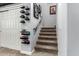Staircase leading up featuring display shelves and a closet with sliding doors at 3931 E Fox Cir, Mesa, AZ 85205