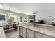 View of an open kitchen concept leading into a dining area and living room with backyard views at 3931 E Fox Cir, Mesa, AZ 85205