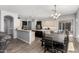 Spacious kitchen with two-tone cabinets, a center island, breakfast bar and adjacent dining area at 3931 E Fox Cir, Mesa, AZ 85205