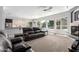 Open-concept living area with fireplace, large windows, view of a pool and a kitchen island at 3931 E Fox Cir, Mesa, AZ 85205