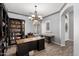 Home office with wood floors, a chandelier, built in bookshelves, and two desks at 3931 E Fox Cir, Mesa, AZ 85205