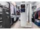 Organized walk-in closet features shelving, hanging racks, mirror, and a security safe at 3931 E Fox Cir, Mesa, AZ 85205