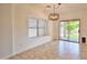 Bright dining area boasts large windows, a modern light fixture, and seamless access to outdoor space at 4119 E Tether Trl, Phoenix, AZ 85050