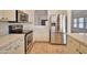 Modern kitchen featuring stainless steel appliances, quartz countertops, and white cabinetry with modern hardware at 4119 E Tether Trl, Phoenix, AZ 85050