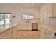 Bright kitchen with stainless steel appliances, quartz countertops, white cabinets and a sliding glass door at 4119 E Tether Trl, Phoenix, AZ 85050