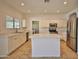 Bright kitchen features white cabinetry, stainless steel appliances, and an island with quartz countertops at 4119 E Tether Trl, Phoenix, AZ 85050