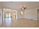 Spacious open-concept living area with natural light, tile flooring, and access to the kitchen and backyard at 4119 E Tether Trl, Phoenix, AZ 85050