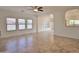 Open living space with a ceiling fan, multiple windows, and a glimpse of the kitchen through an arched opening at 4119 E Tether Trl, Phoenix, AZ 85050