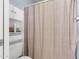 This bathroom features white toilet and cabinet, and an abstract design shower curtain at 4631 N 77Th Dr, Phoenix, AZ 85033