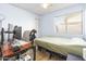 This bedroom includes a desk, bed, rolling chair, and a bright window at 4631 N 77Th Dr, Phoenix, AZ 85033