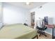 This bedroom features a bright window, hardwood floors, a ceiling fan, and an organized workspace at 4631 N 77Th Dr, Phoenix, AZ 85033