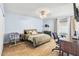 Cozy primary bedroom featuring modern furniture, hardwood floors, and a calming color palette at 4631 N 77Th Dr, Phoenix, AZ 85033