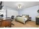 This bedroom offers hardwood floors, a ceiling fan, a wardrobe, and a sleek desk with a rolling chair at 4631 N 77Th Dr, Phoenix, AZ 85033