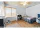 Cozy bedroom featuring light-colored walls, hardwood floors, and a window for natural light at 4631 N 77Th Dr, Phoenix, AZ 85033