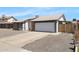 View of the home's front exterior, showcasing the garage, driveway, and desert landscaping at 4631 N 77Th Dr, Phoenix, AZ 85033