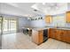 Eat-in kitchen with granite counters, stainless steel sink, oak cabinets, and sliding door to patio at 4631 N 77Th Dr, Phoenix, AZ 85033