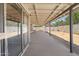 Covered patio with a concrete slab and sliding glass door overlooking a spacious backyard with play equipment at 4631 N 77Th Dr, Phoenix, AZ 85033